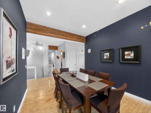 Dining area featuring hardwood flooring and exposed wood ceiling beam - 569 Butterworth Way, Edmonton, AB - Indoor Photo Showing Dining Room