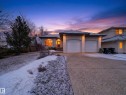 Stucco exterior residence with an arched entryway, prominent two-car garage, and concrete driveway - 569 Butterworth Way, Edmonton, AB  - Outdoor 