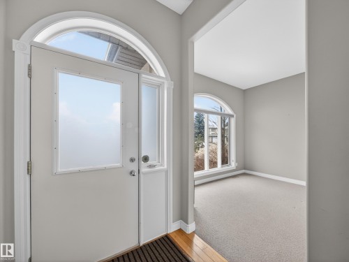 Entryway with an arched transom window above the main door and sidelight - 569 Butterworth Way, Edmonton, AB - Indoor Photo Showing Other Room