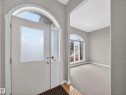 Entryway with an arched transom window above the main door and sidelight - 569 Butterworth Way, Edmonton, AB  - Indoor Photo Showing Other Room 