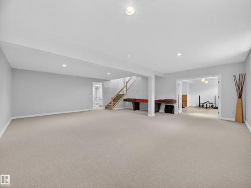 Carpeted open-concept lower level with recessed lighting and light gray wall paint - 569 Butterworth Way, Edmonton, AB - Indoor Photo Showing Other Room