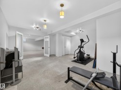 Spacious lower-level area with concrete flooring and recessed lighting - 