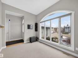 Arch-top window with multi-pane design and white trim - 