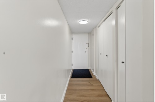 Entryway featuring wood-finish flooring, white walls, and a ceiling-mounted light fixture - 90 8745 165 Street, Edmonton, AB - Indoor Photo Showing Other Room