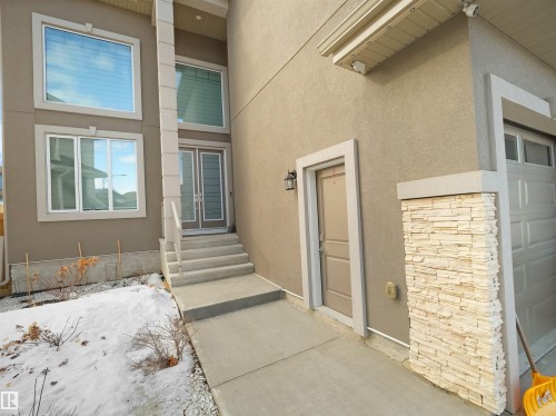 Contemporary exterior featuring a stucco finish, multi-pane windows, and a double-door entry - 1208 25 St Nw, Edmonton, AB - Outdoor With Exterior