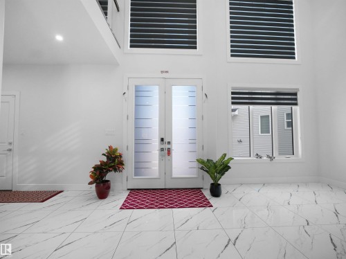 Double entry doors with privacy glass panels - 1208 25 St Nw, Edmonton, AB - Indoor Photo Showing Other Room