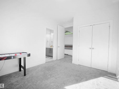 White-painted interior with light gray carpeting - 1208 25 St Nw, Edmonton, AB - Indoor Photo Showing Other Room
