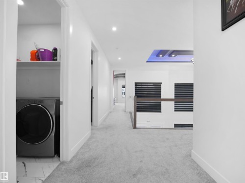 Hallway featuring light gray carpeting, recessed ceiling lighting, and crisp white baseboards - 1208 25 St Nw, Edmonton, AB - Indoor Photo Showing Laundry Room