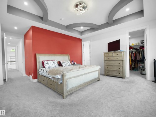 Spacious room featuring light gray carpeting and a tray ceiling with integrated lighting - 1208 25 St Nw, Edmonton, AB - Indoor Photo Showing Bedroom