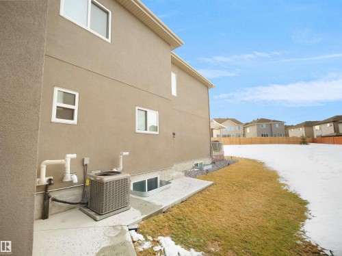 Stucco exterior with multiple white-framed windows - 1208 25 St Nw, Edmonton, AB - Outdoor With Exterior