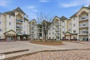 Multi-story residential complex featuring multiple private balconies with glass railings - 120 13625 34 Street, Edmonton, AB  - Outdoor With Balcony With Facade 