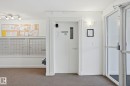 Community entrance featuring secure mailboxes, track lighting, and a glass-paneled entry door - 120 13625 34 Street, Edmonton, AB  - Indoor Photo Showing Other Room 