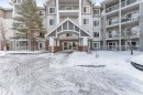 Multi-story residential building with a covered entrance featuring gabled architecture - 201 4403 23 Street, Edmonton, AB  - Outdoor With Balcony With Facade 
