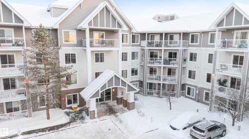 Multi-story building featuring a pitched roofline and a gabled main entrance - 201 4403 23 Street, Edmonton, AB - Outdoor With Balcony With Facade