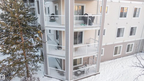 Multi-story residential building featuring private balconies with white railings and sliding glass doors - 201 4403 23 Street, Edmonton, AB - Outdoor With Balcony With Exterior