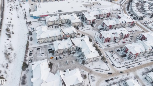 Residential development featuring multiple multi-story buildings with pitched roofs and exterior parking - 201 4403 23 Street, Edmonton, AB - Other