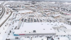 Large commercial building with a vast parking lot - 