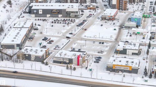 Commercial development featuring multiple buildings with snow-covered rooftops and surrounding grounds - 201 4403 23 Street, Edmonton, AB - Other
