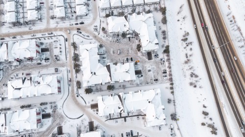 Aerial perspective of a multi-building residential complex featuring pitched roofs and multiple parking areas - 201 4403 23 Street, Edmonton, AB - Other