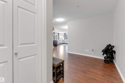 Hardwood-finish flooring throughout, complemented by light gray wall paint and white trim - 