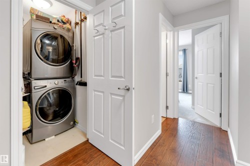 Dedicated laundry closet featuring a stacked washer and dryer unit - 201 4403 23 Street, Edmonton, AB - Indoor Photo Showing Laundry Room