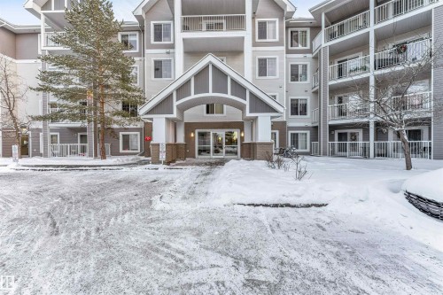 Multi-story residential building with a covered entrance featuring gabled architecture - 201 4403 23 Street, Edmonton, AB - Outdoor With Balcony With Facade