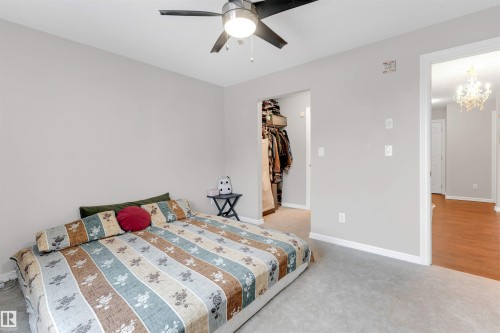Room featuring light gray walls, carpet flooring, and a ceiling fan with integrated lighting - 201 4403 23 Street, Edmonton, AB - Indoor Photo Showing Bedroom