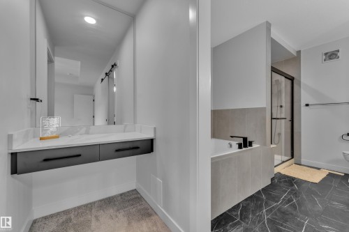 Floating vanity with a light-toned countertop and dark cabinetry - 5722 Kootook Way, Edmonton, AB - Indoor Photo Showing Bathroom