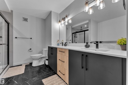Dual vanity with white countertop and integrated sinks - 5722 Kootook Way, Edmonton, AB - Indoor Photo Showing Bathroom