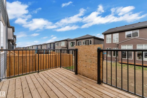 Outdoor wood-finish deck featuring black metal railings - 5722 Kootook Way, Edmonton, AB - Outdoor With Exterior