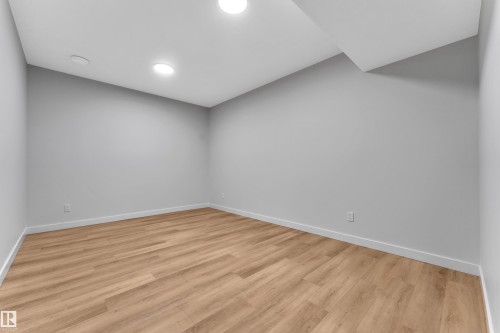 Room featuring light wood-finish flooring, light gray wall paint, white trim, and recessed lighting - 5722 Kootook Way, Edmonton, AB - Indoor Photo Showing Other Room