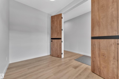 Entryway featuring light wood-finish flooring, white baseboards, and a recessed ceiling light - 5722 Kootook Way, Edmonton, AB - Indoor Photo Showing Other Room