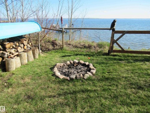 Firepit at the lakefront - 45 Poplar Bay, Rural Wetaskiwin County, AB - Outdoor With Body Of Water With View