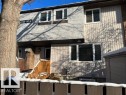 Multi-level exterior featuring vertical siding, stucco accents, and white-framed windows - 11 14120 80 Street, Edmonton, AB  - Outdoor 