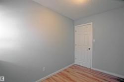 Light gray wall paint with white baseboards and wood-finish flooring - 