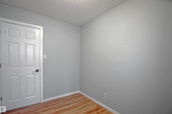 Light gray painted walls with wood-finish flooring - 