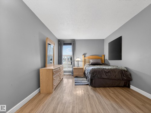 Bright room featuring wood-finish flooring, light gray walls, and a window with white trim - 165 2703 79 Street, Edmonton, AB - Indoor Photo Showing Bedroom