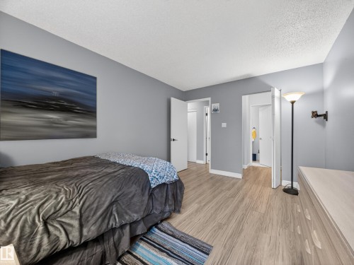 Bedroom featuring wood-finish flooring, light grey painted walls, and white trim - 165 2703 79 Street, Edmonton, AB - Indoor Photo Showing Bedroom