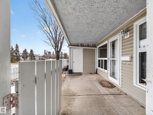 Covered concrete patio with white privacy fencing - 165 2703 79 Street, Edmonton, AB - Outdoor With Exterior