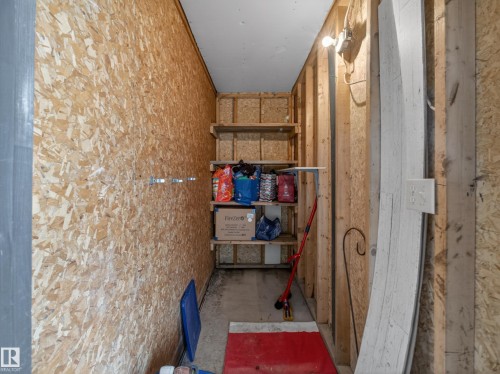 Utility room with built-in shelving, exposed wood-finish walls, and a concrete floor - 165 2703 79 Street, Edmonton, AB - Indoor