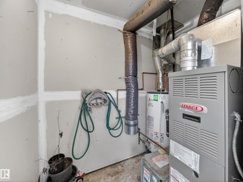 Utility area featuring a Lennox furnace system and a water heater, with exposed ductwork and unfinished drywall walls - 165 2703 79 Street, Edmonton, AB - Indoor Photo Showing Basement