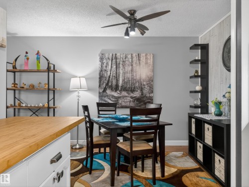 Dining area featuring wood-finish flooring, a ceiling fan with integrated lighting, and neutral wall tones - 165 2703 79 Street, Edmonton, AB - Indoor Photo Showing Dining Room