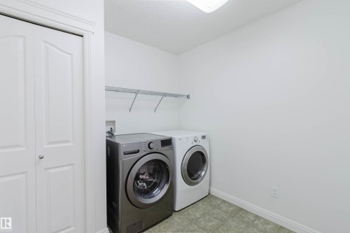 Dedicated utility space featuring tile flooring and overhead shelving - 1951 120 Street, Edmonton, AB - Indoor Photo Showing Laundry Room