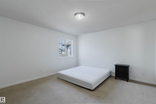 Room featuring light-colored carpet flooring, white walls, and white baseboards - 1951 120 Street, Edmonton, AB - Indoor Photo Showing Bedroom