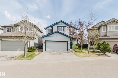 Two-story residence featuring white siding with dark teal trim accents - 1951 120 Street, Edmonton, AB - Outdoor With Facade