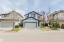 Two-story residence featuring white siding with dark teal trim accents - 1951 120 Street, Edmonton, AB  - Outdoor With Facade 