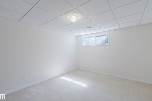 Room featuring light-colored carpeting, white baseboards, and a white ceiling with recessed lighting - 1951 120 Street, Edmonton, AB - Indoor Photo Showing Other Room