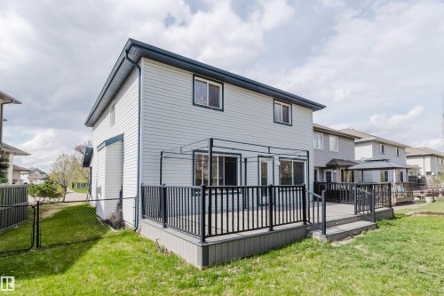 Spacious rear deck featuring dark railings and an integrated pergola structure - 1951 120 Street, Edmonton, AB - Outdoor With Deck Patio Veranda With Exterior