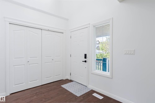 Entryway featuring wood-finish flooring and bright white walls - 1951 120 Street, Edmonton, AB - Indoor Photo Showing Other Room