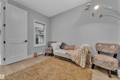 Light wood-finish flooring with a neutral wall color - 8025 174A Avenue, Edmonton, AB - Indoor